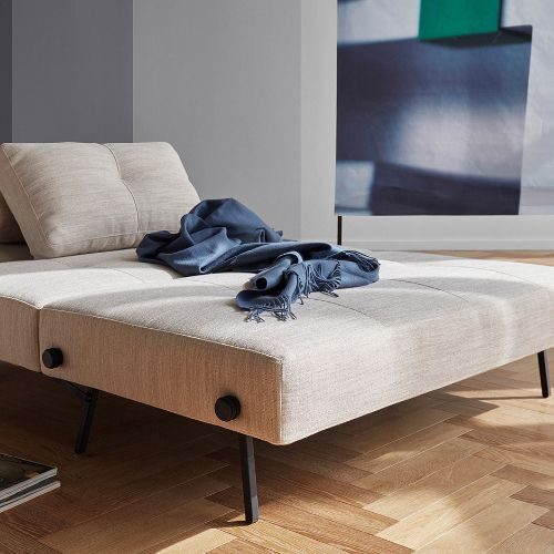 Compact sofa bed with storage compartments