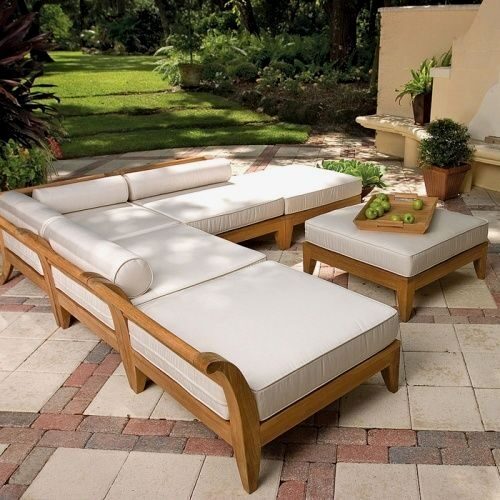 Contemporary wooden outdoor lounge set with plush white cushions