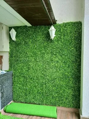 Artificial green foliage covering indoor wall with lighting