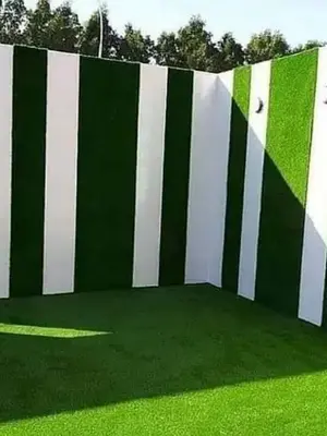 Striped green and white wall panels with grassy floor